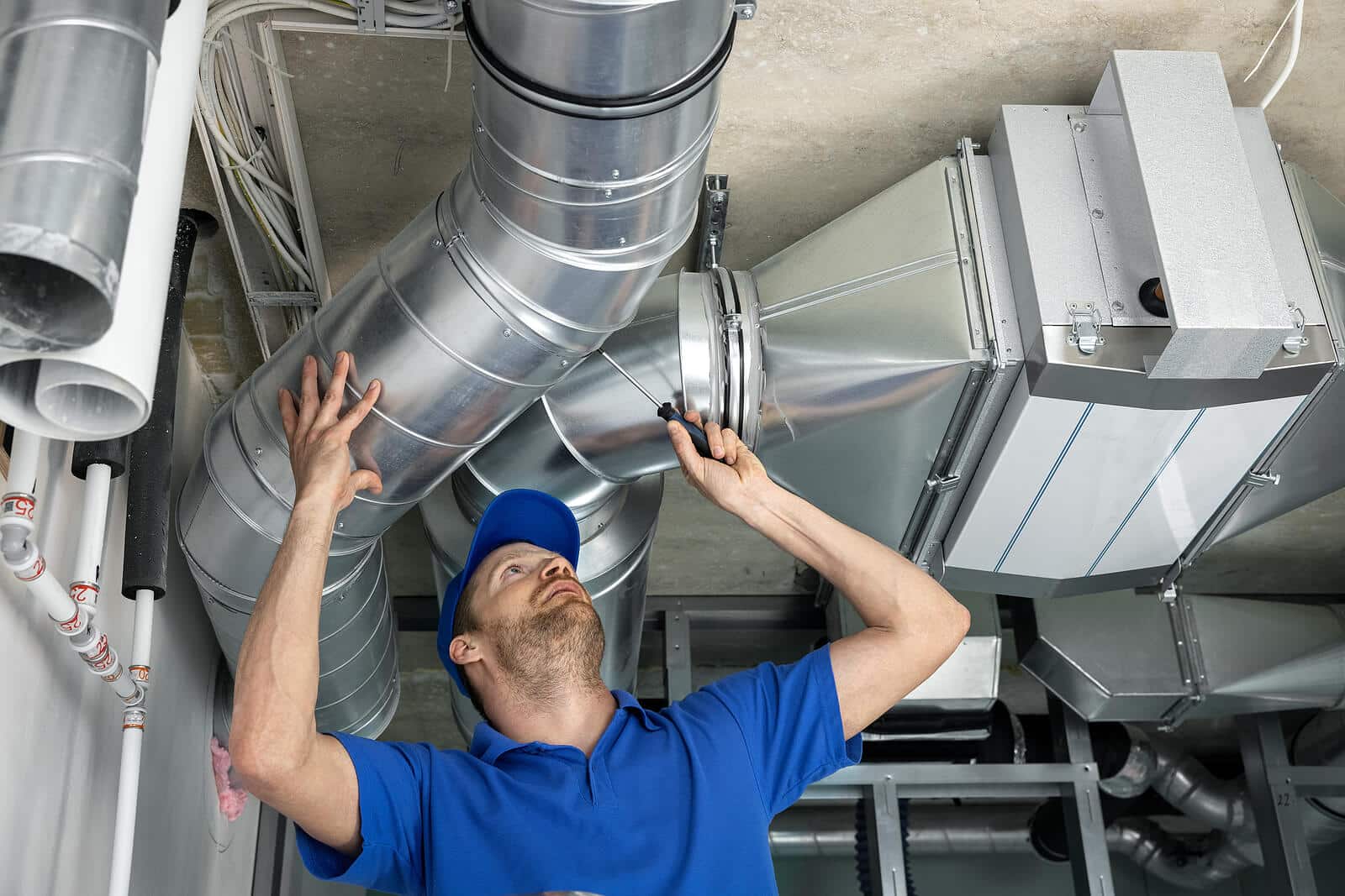 HVAC technician inspecting and repairing air ducts in Covina