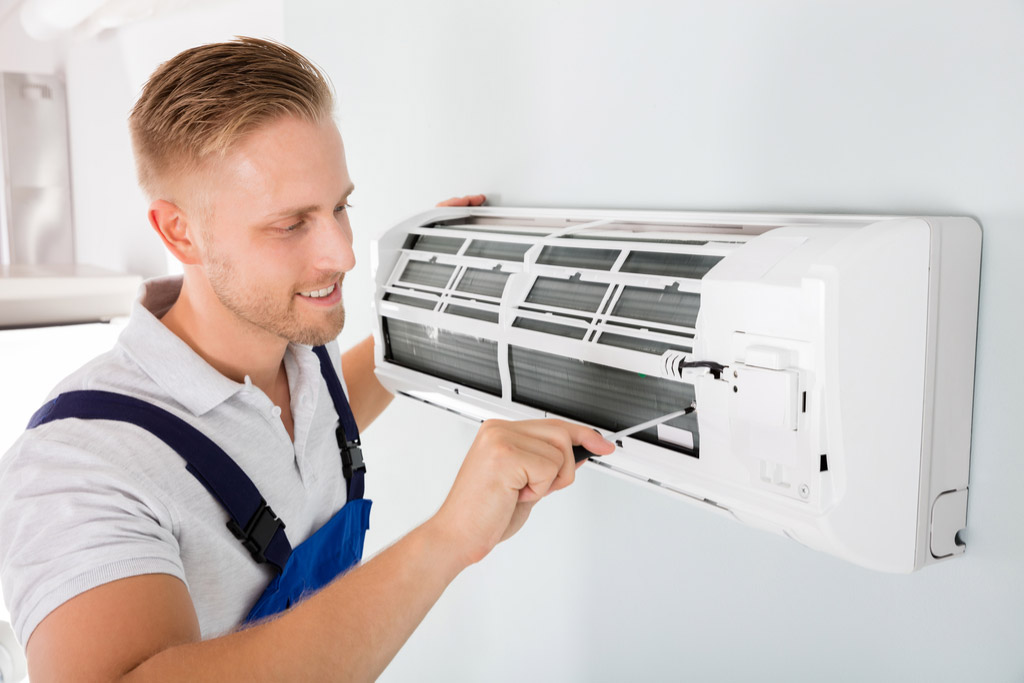 HVAC technician maintaining a ductless air conditioner in Covina