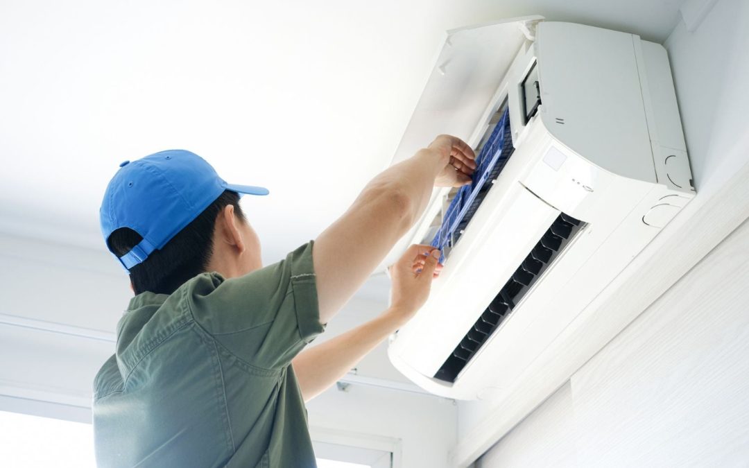 HVAC technician servicing a ductless mini split in Covina