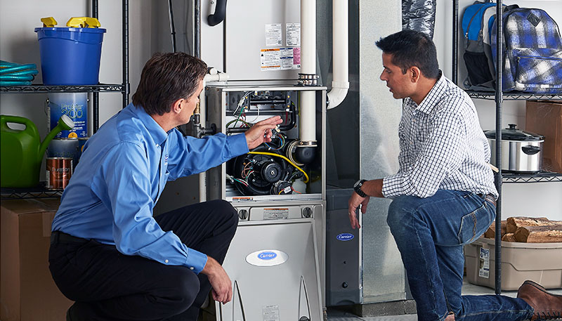 Technician evaluating a furnace for repair or replacement in Covina