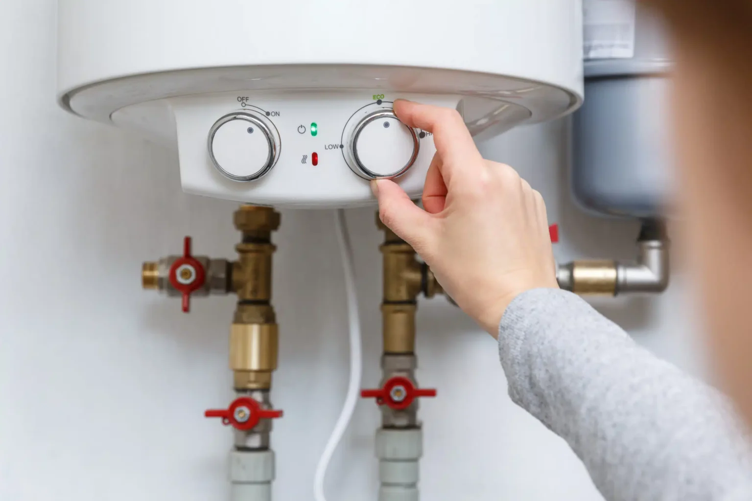 Technician adjusting a water heater in Covina